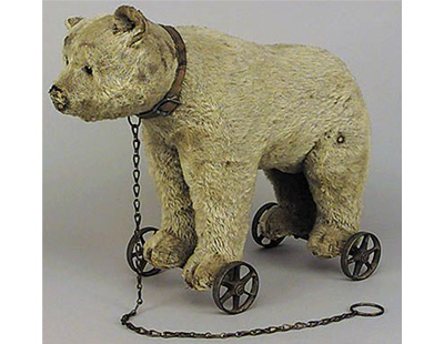 A blonde mohair bear on wheels, early German, c.1915, head with centre seam