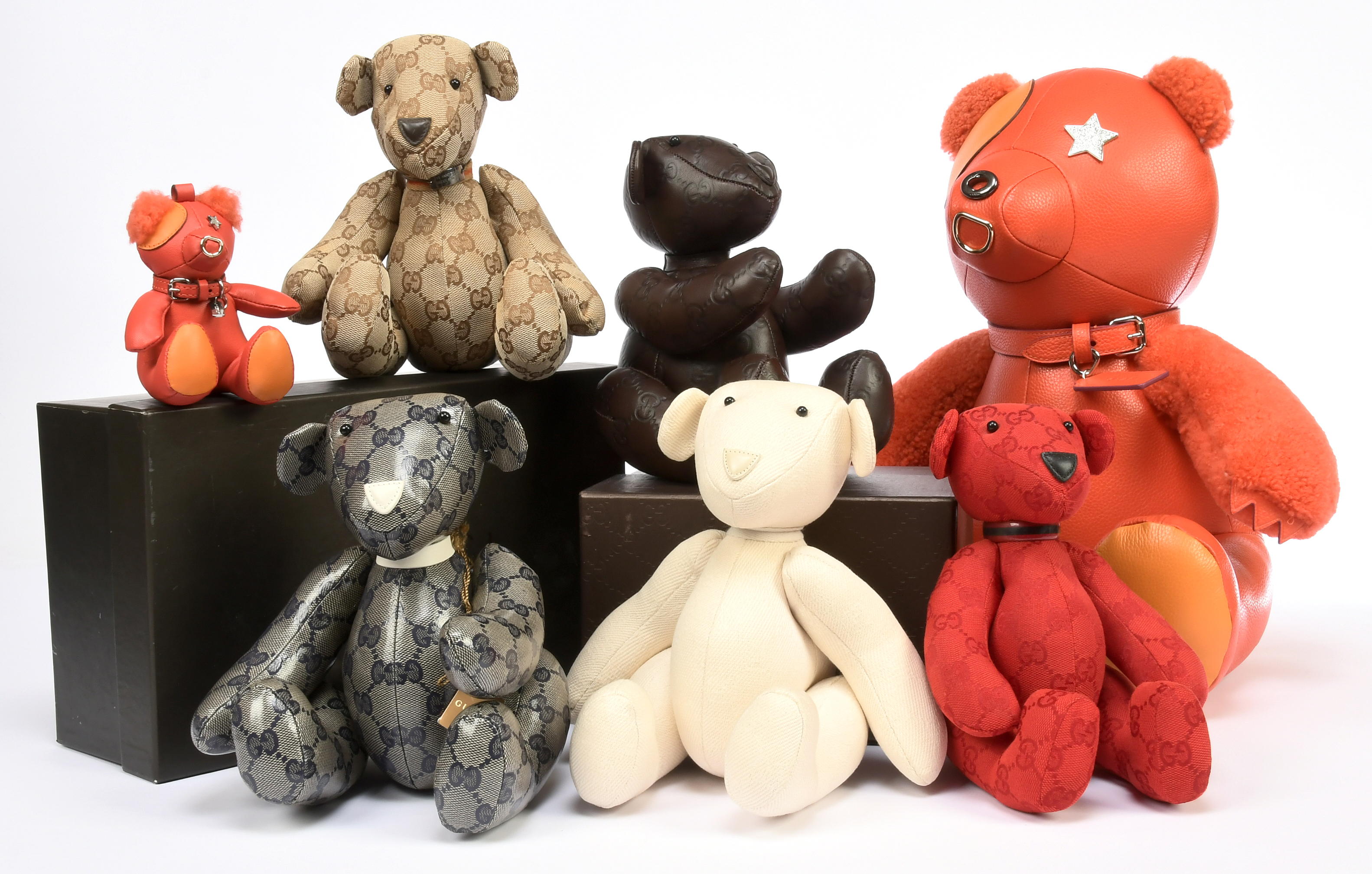 A selection of designer branded bears and miniature bag charms in our July Doll & Teddy Bear Auction